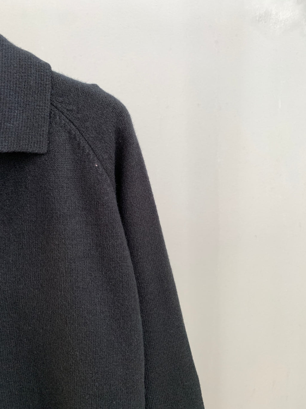 Dark knit cardigan sleeve and shoulder seam