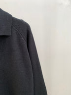 Dark knit cardigan sleeve and shoulder seam