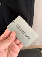 Knit cardigan garment tag near the button placket
