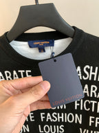 Black crewneck sweater neckline with Louis Vuitton label and white graphic text