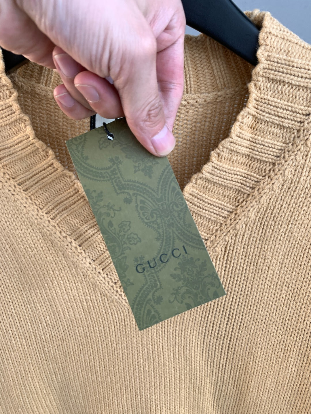 Gucci knit sweater neckline with green tag and fabric care label