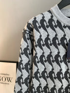 White and black patterned knit sweater long sleeve detail, ribbed crew neck