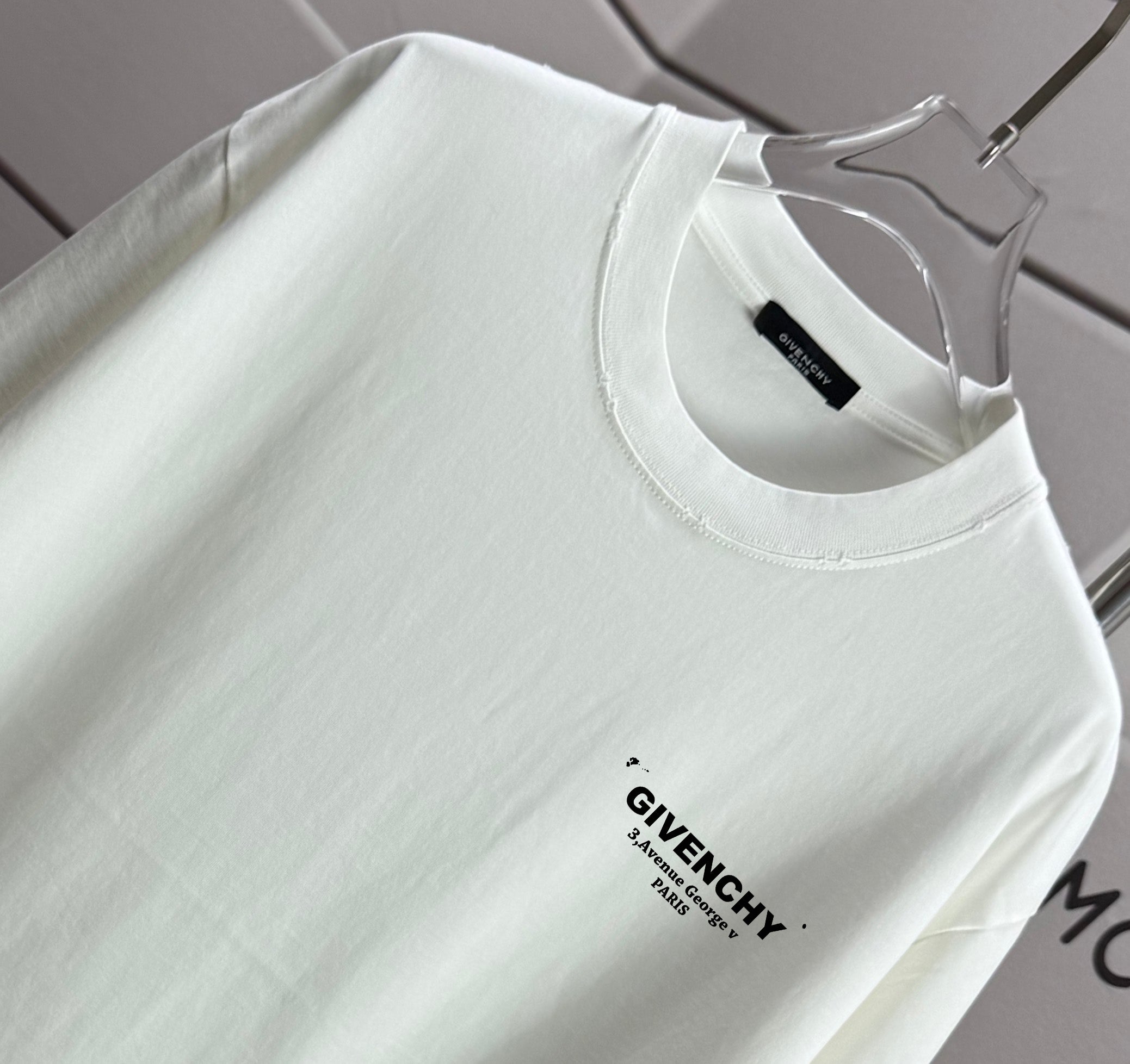 White Givenchy T-shirt close-up of crew neck and chest logo print