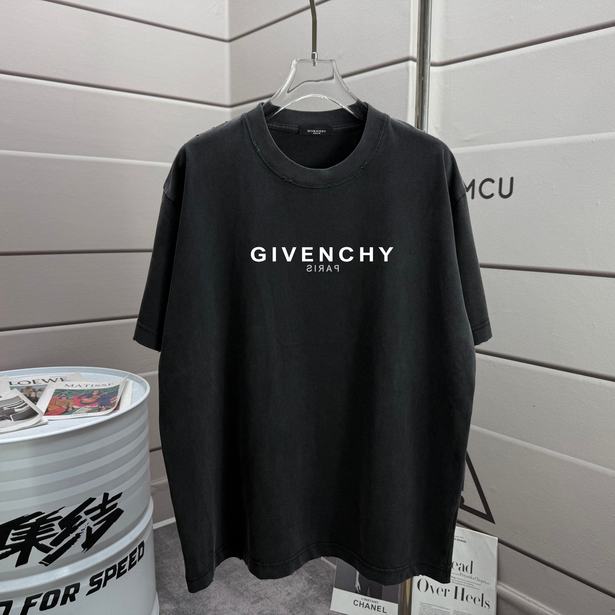 Black T-shirt with GIVENCHY logo and Paris text on the chest.