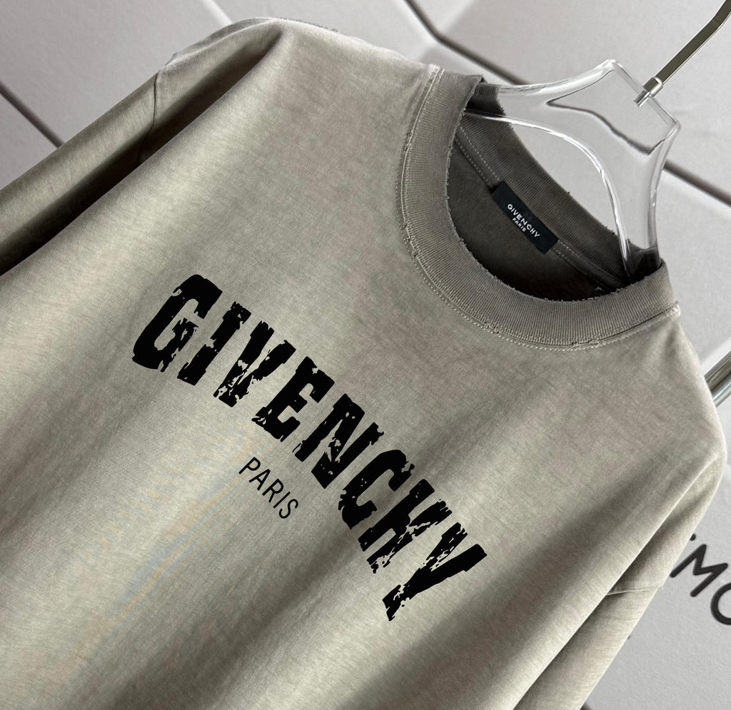 Givenchy T-shirt close-up: “GIVENCHY” print with “PARIS” below, sage gray