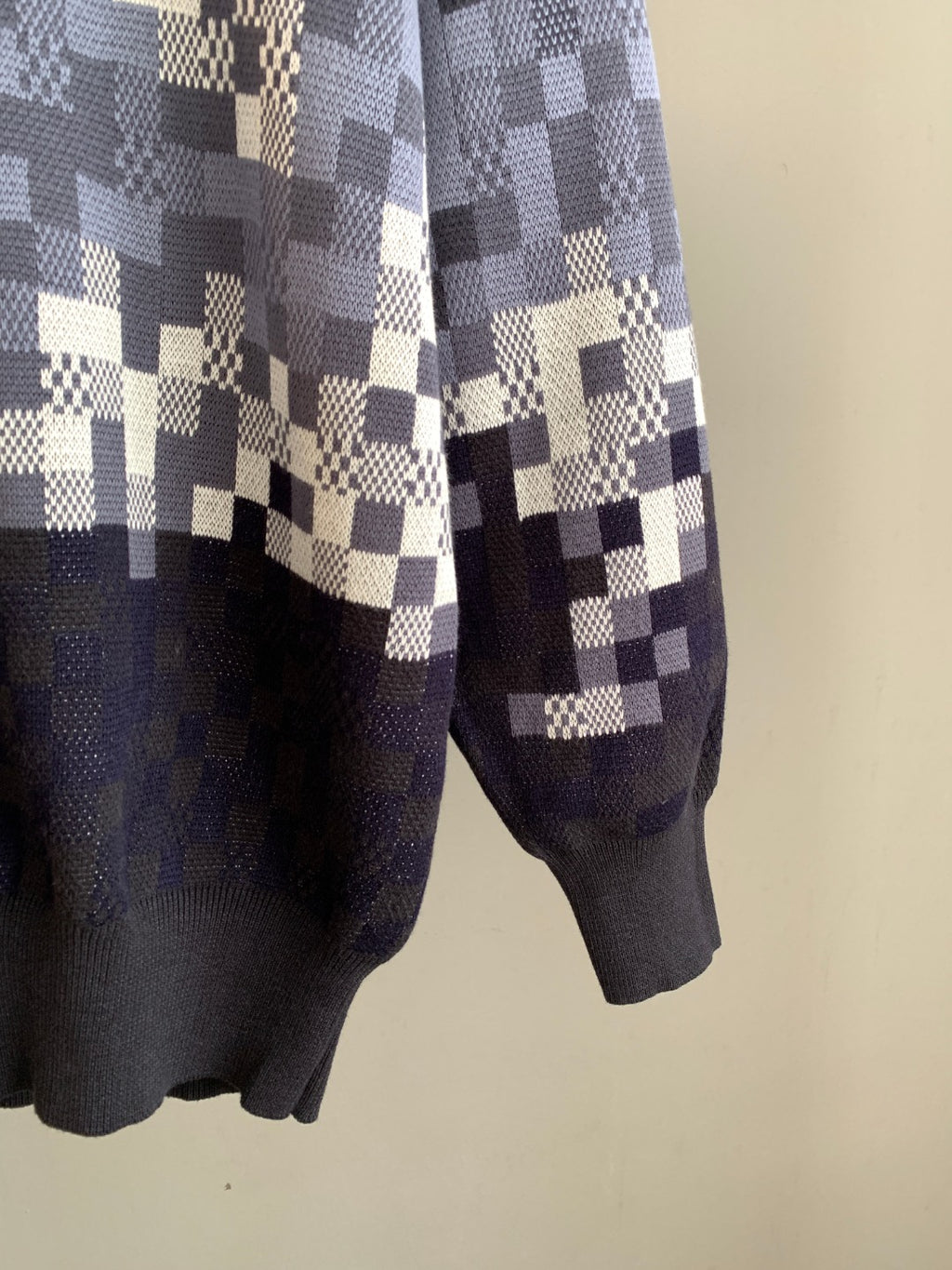 Louis Vuitton check knit sweater sleeve detail with navy cuffs and white blocks