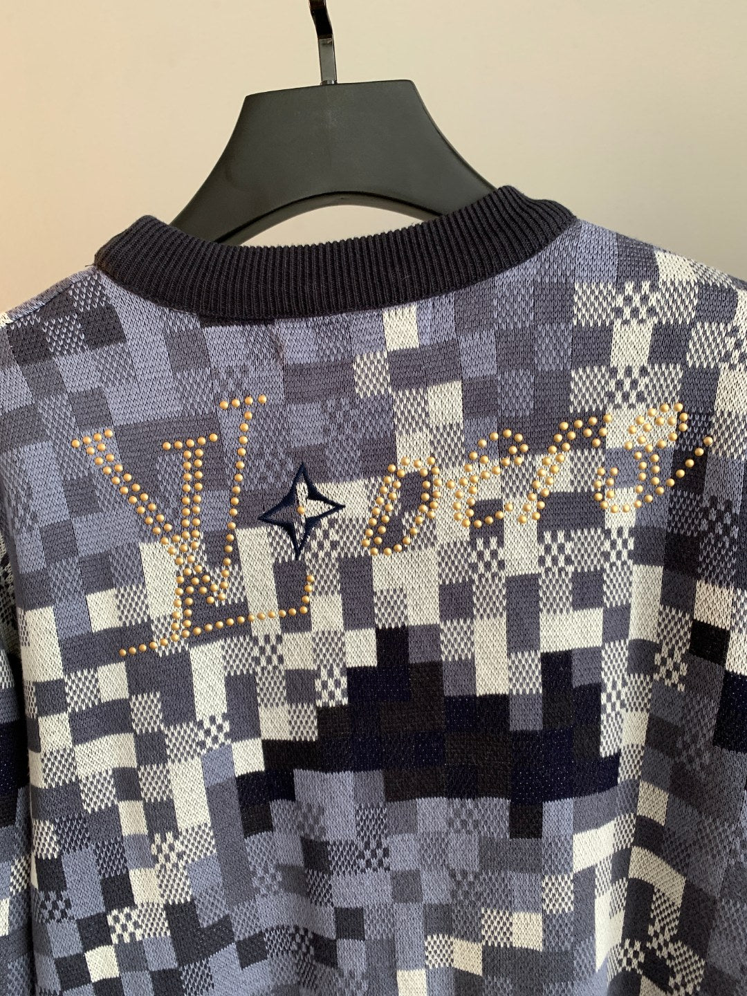 Louis Vuitton check knit sweater front close-up with gold logo detail and crew neck