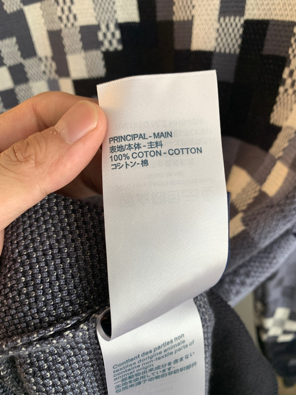 Louis Vuitton sweater care label reading 100% cotton inside fabric