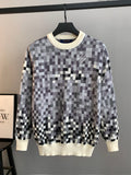 Louis Vuitton long-sleeve sweater with black-and-white check pattern and cream ribbed hem