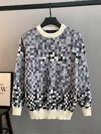 Louis Vuitton long-sleeve sweater with black-and-white check pattern and cream ribbed hem