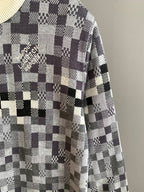 Louis Vuitton sweater sleeve in black-and-white check knit with cream ribbed cuff