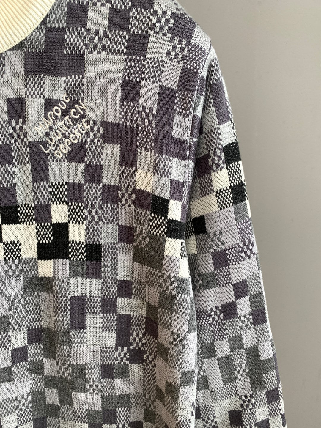 Louis Vuitton sweater sleeve in black-and-white check knit with cream ribbed cuff