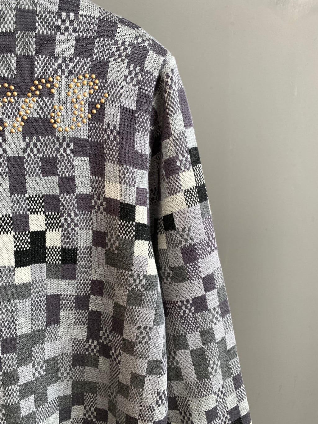 Louis Vuitton sweater side view in black-and-white check knit, long sleeves