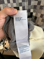 Louis Vuitton care label tag reading 100% cotton on check knit sweater