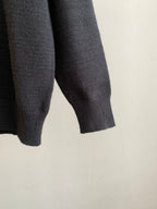 Charcoal knit sweater sleeve with ribbed cuff and textured knit hem