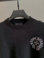 Charcoal knit sweater with ribbed crew neck and circular front logo emblem