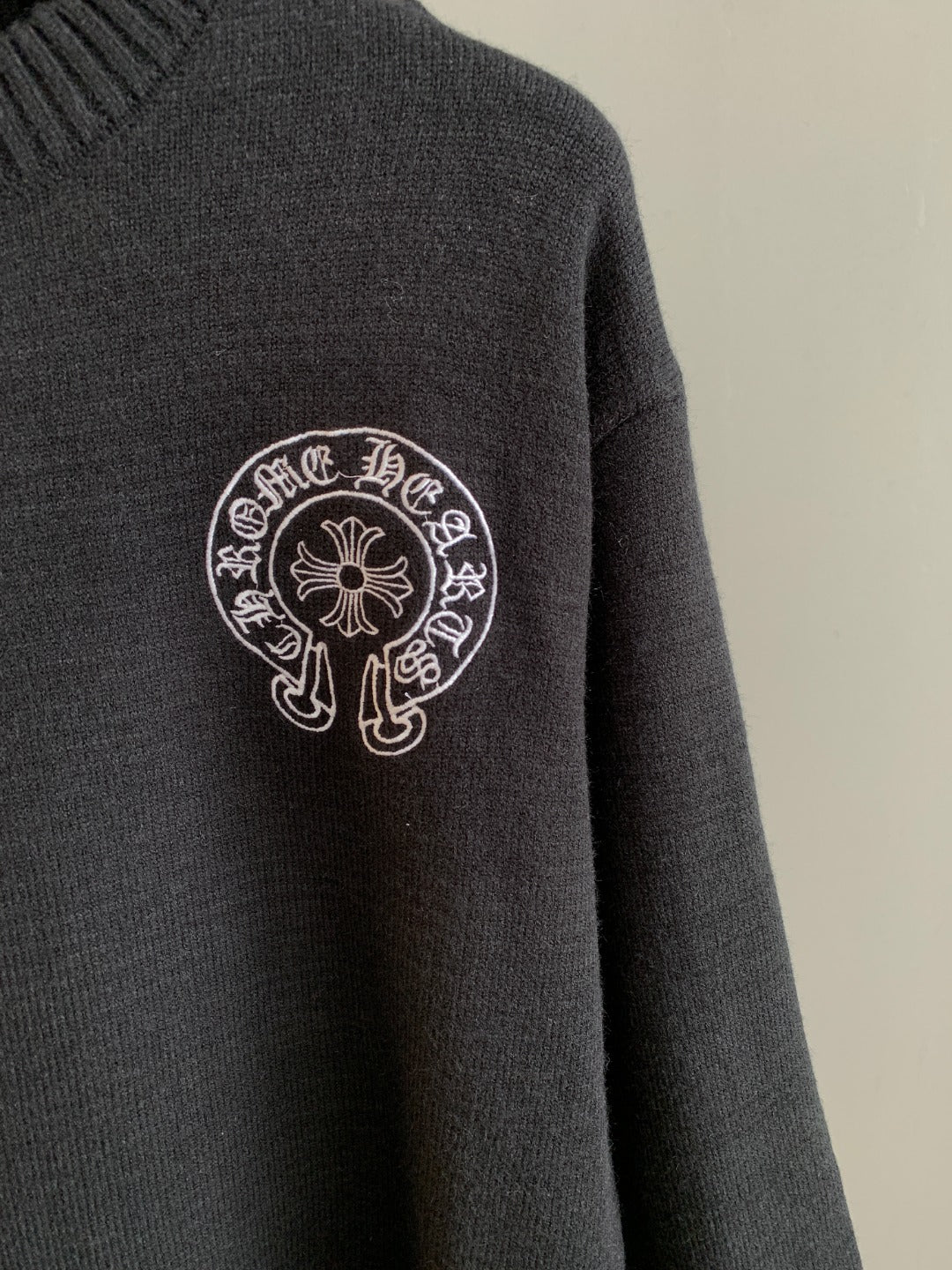 Charcoal knit sweater with small chest circular logo emblem