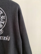 Charcoal knit sweater with partial side graphic logo and ribbed crew neckline