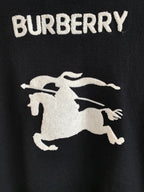 Burberry sweater with large white horse emblem graphic on dark knit