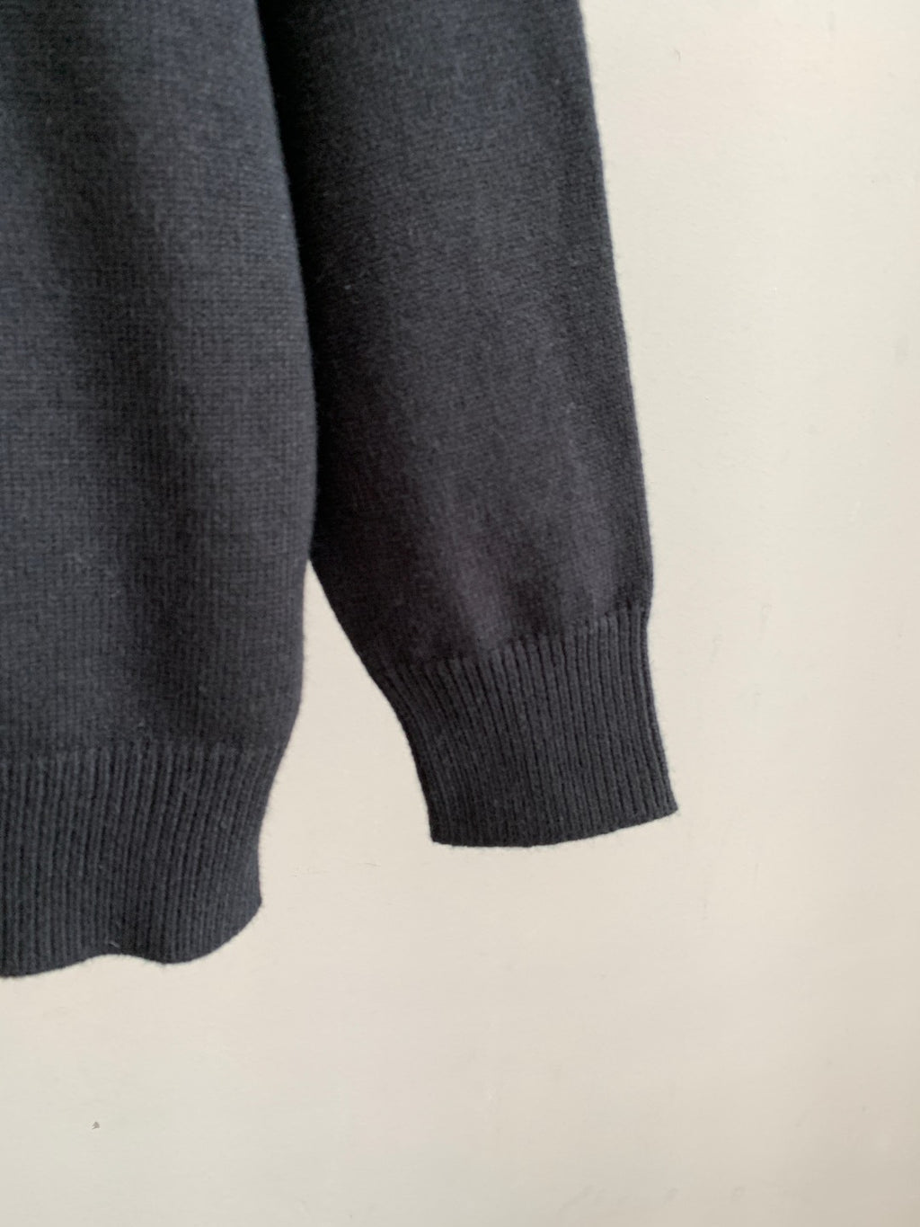 Long-sleeve knit sweater sleeve cuff in dark tone with ribbed hem