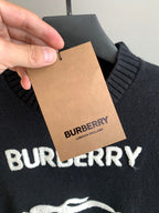 Burberry sweater close-up with attached hang tag and BURBERRY text near logo