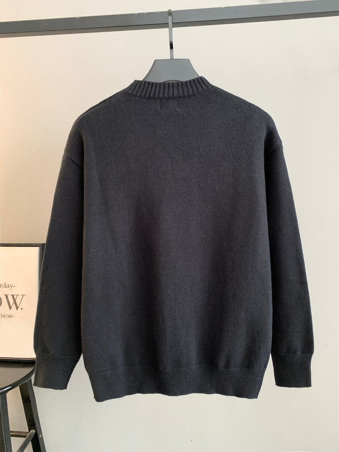 Dark long-sleeve knit sweater back view with ribbed crew neck
