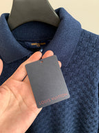 Blue knit sweater neck with Louis Vuitton label and hanging clothing tag