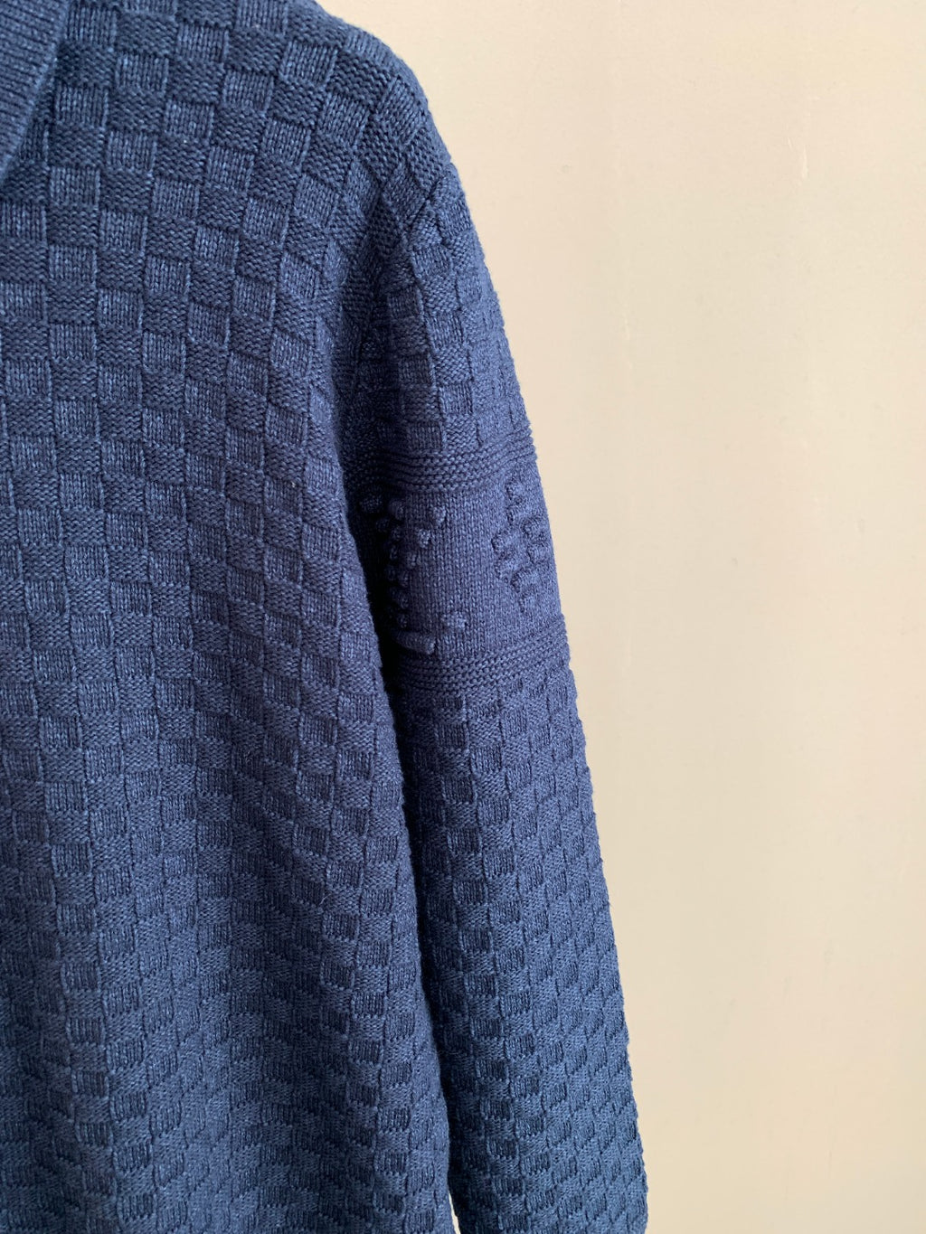 Blue textured knit sweater sleeve and side panel