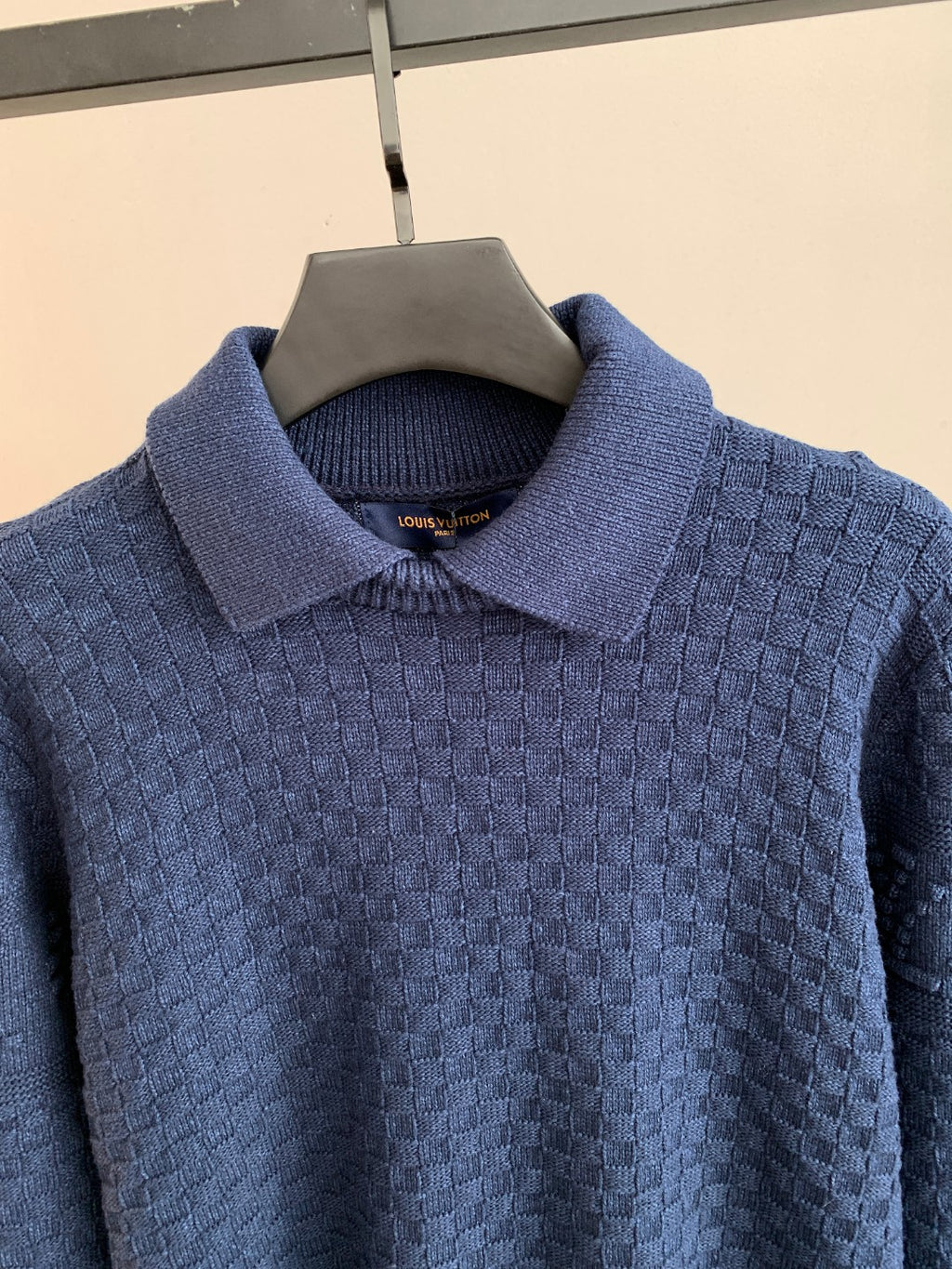 Blue knit sweater with raised collar and textured stitch pattern
