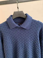 Blue knit sweater with raised collar and textured stitch pattern