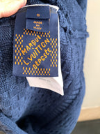 Blue knit sweater label tag with size and care details, Louis Vuitton