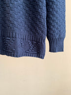 Blue knit sweater hem with ribbed cuff and textured stitch detailing