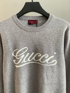 Grey sweatshirt with Gucci script logo on chest