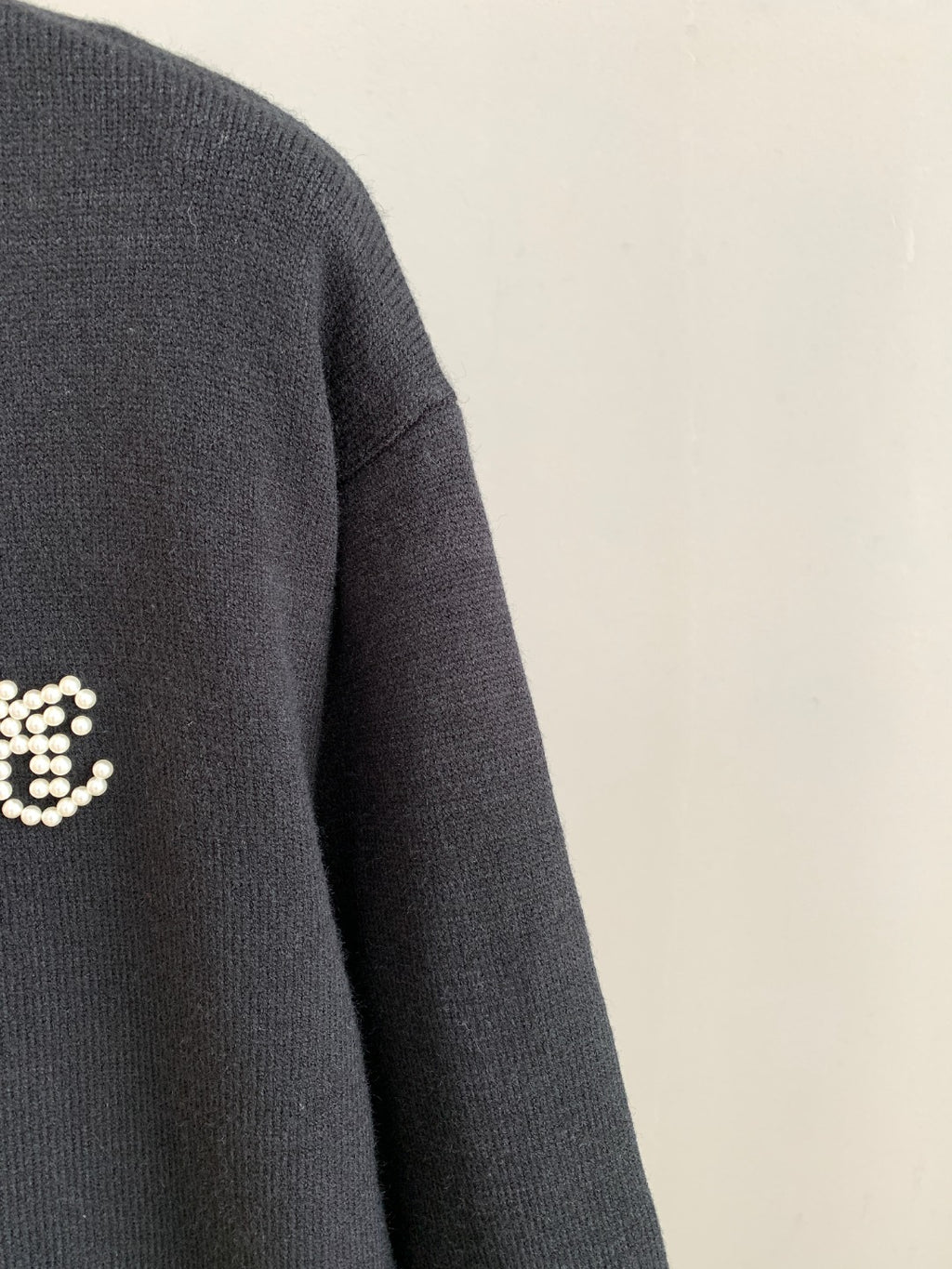Charcoal knit sweater sleeve and shoulder seam detail
