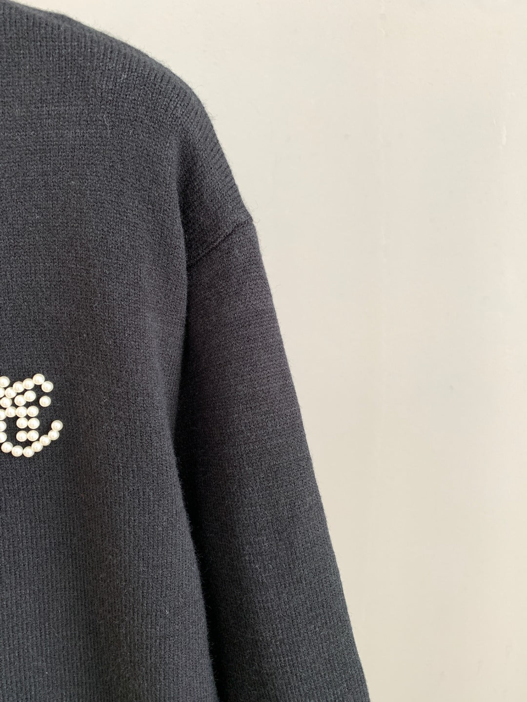 Charcoal knit sweater sleeve and shoulder seam detail