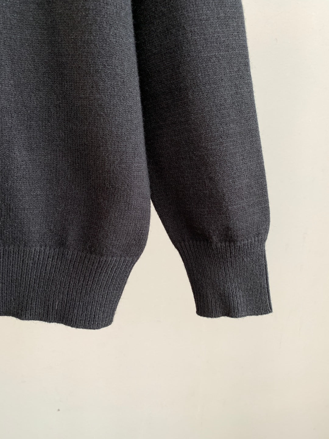 Charcoal knit sweater sleeve with ribbed cuff detail