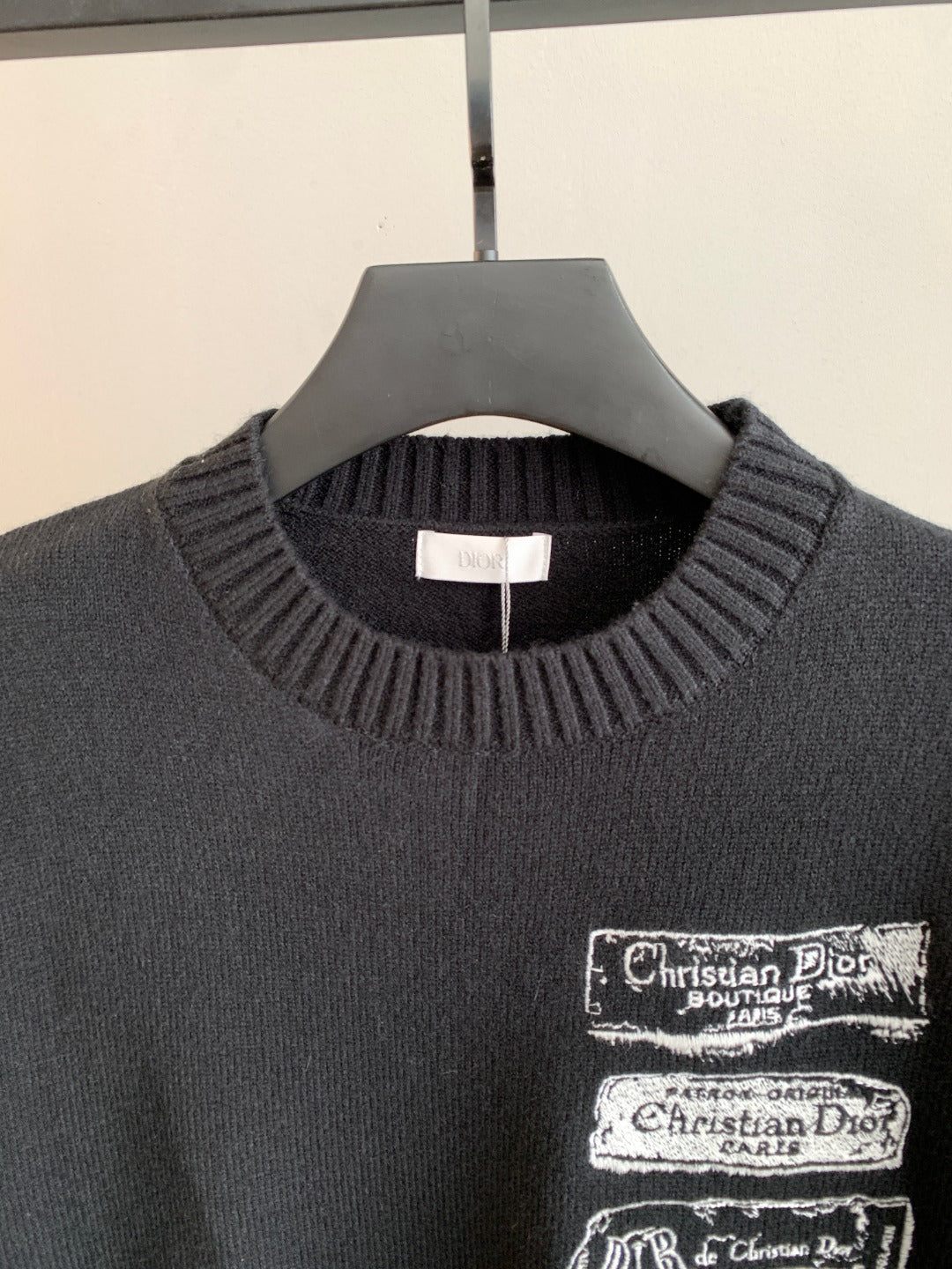 Dark ribbed crewneck sweater with Christian Dior logo patch at chest