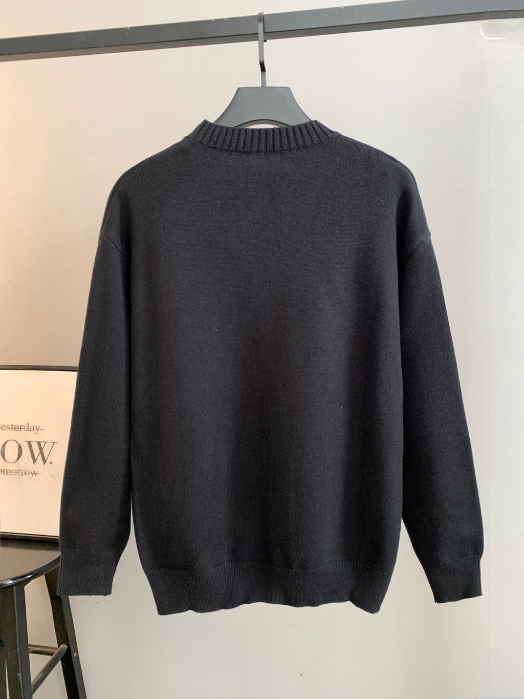 Dark crewneck knit sweater with long sleeves and ribbed hem and collar