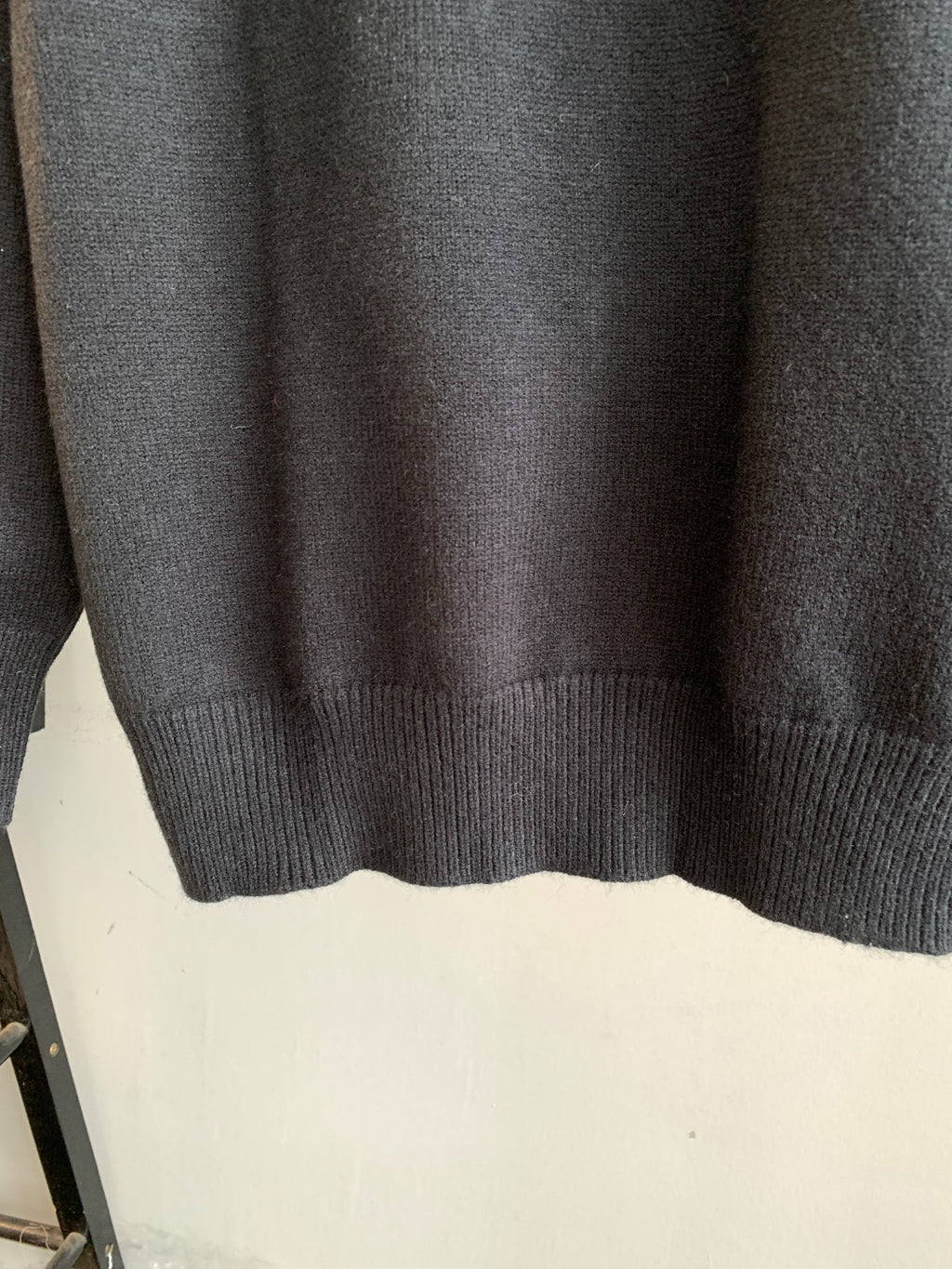 Dark knit sweater with ribbed cuffs and ribbed hem
