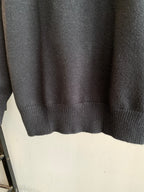Dark knit sweater with ribbed cuffs and ribbed hem