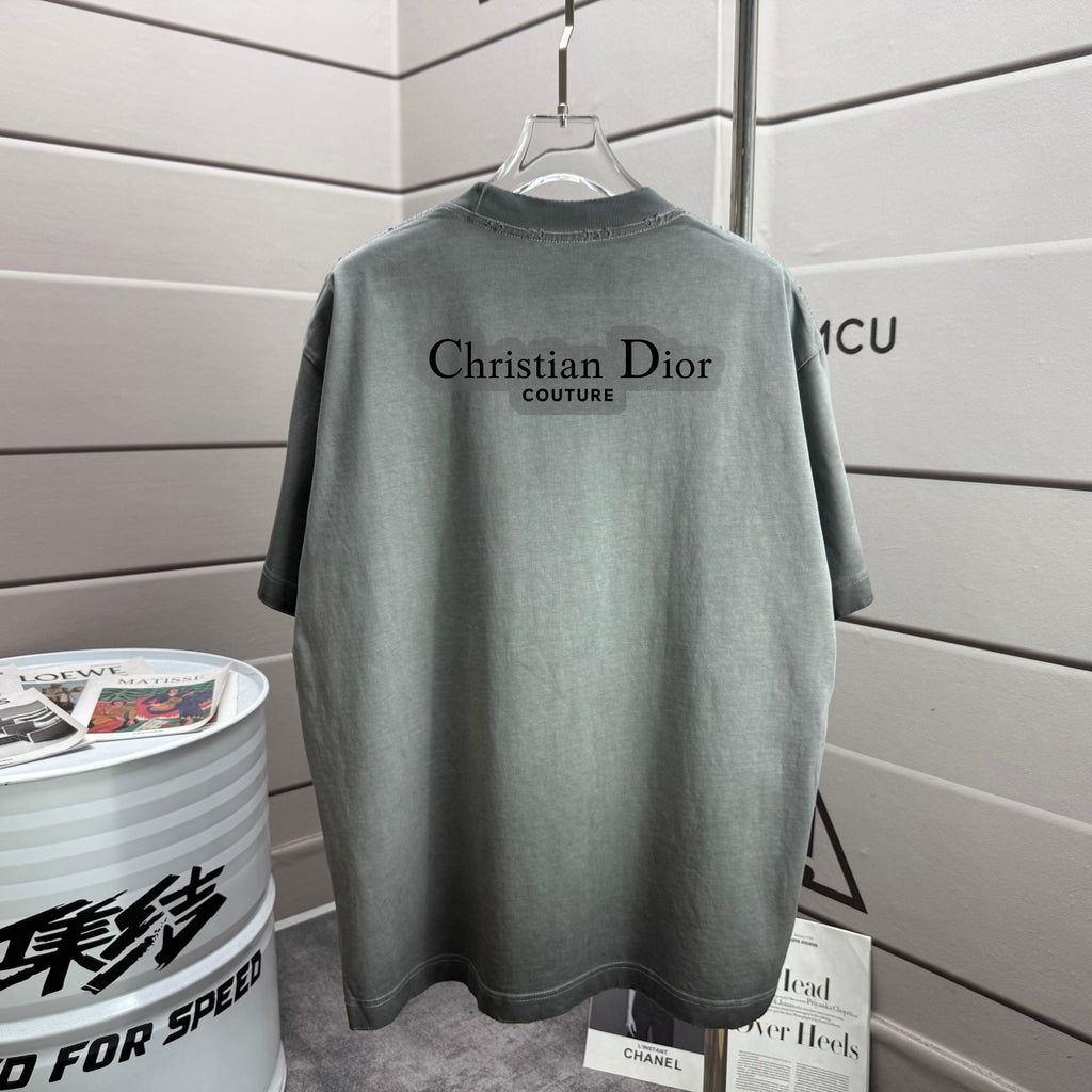 Light gray short-sleeve T-shirt with Christian Dior logo print on back.