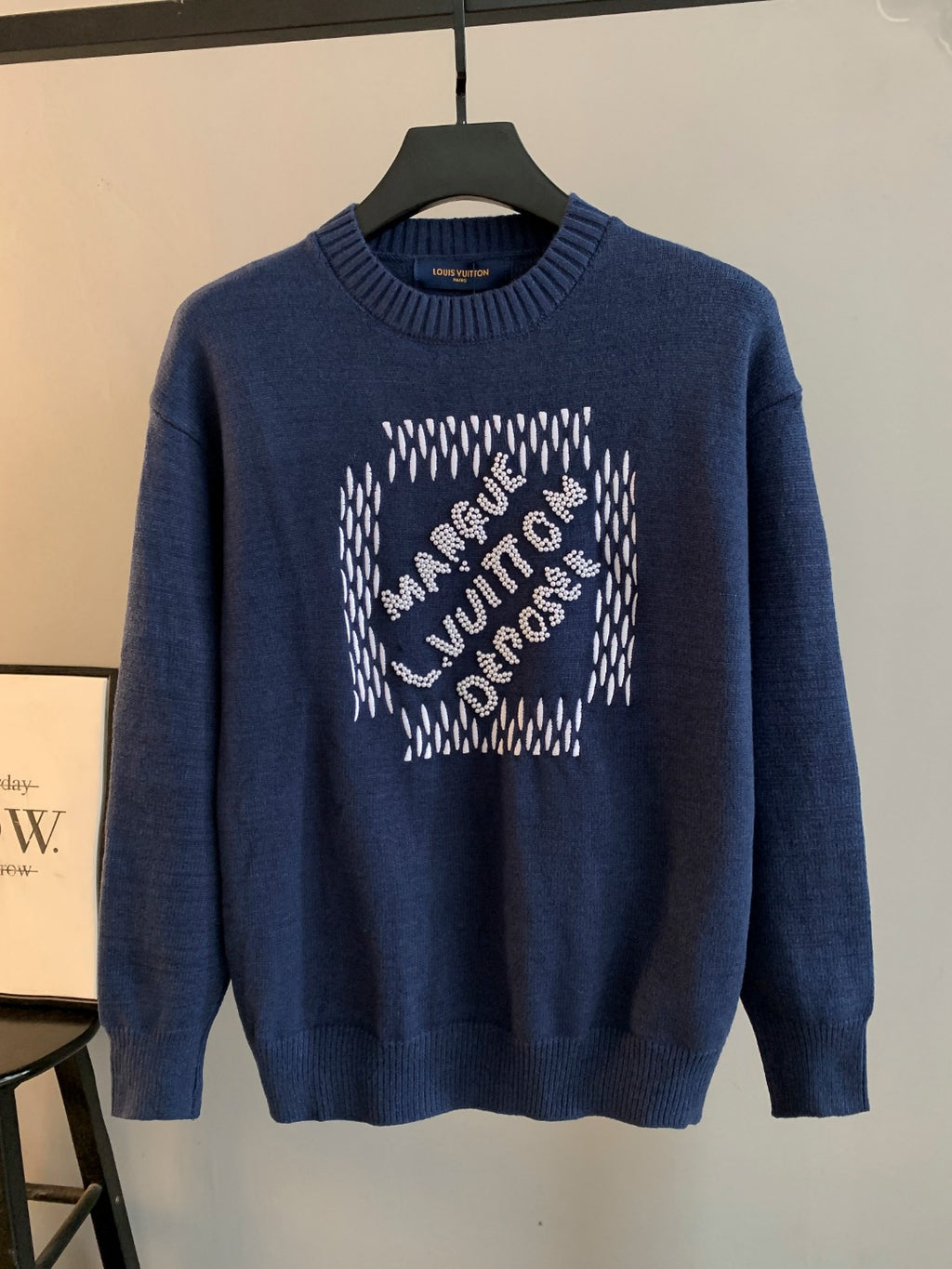 Navy blue knit crewneck sweater with beaded graphic on front