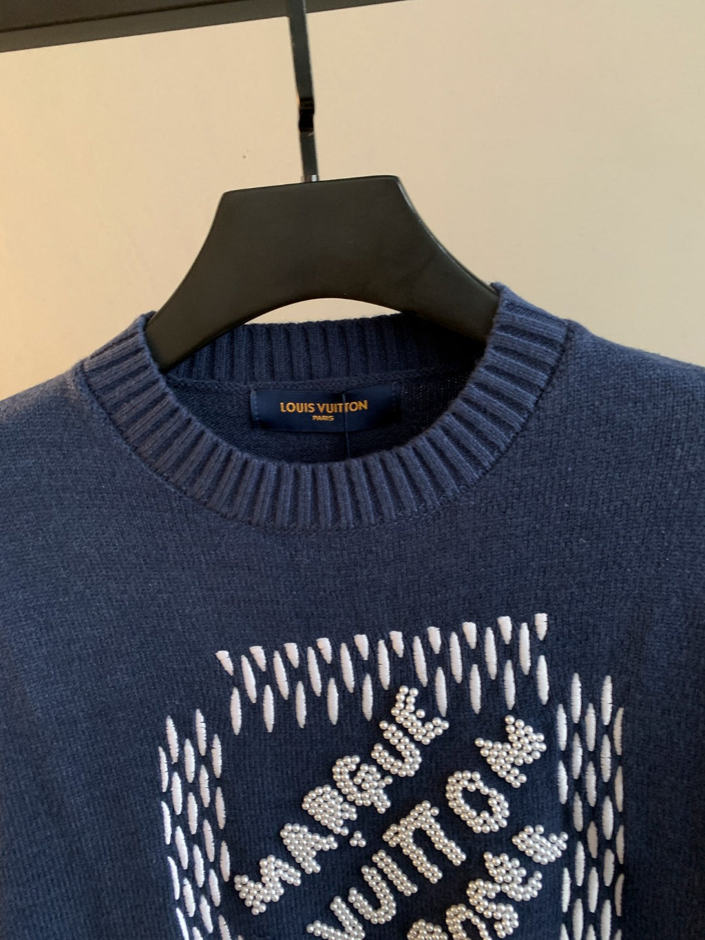 Navy blue knit crewneck sweater with Louis Vuitton label and beaded graphic
