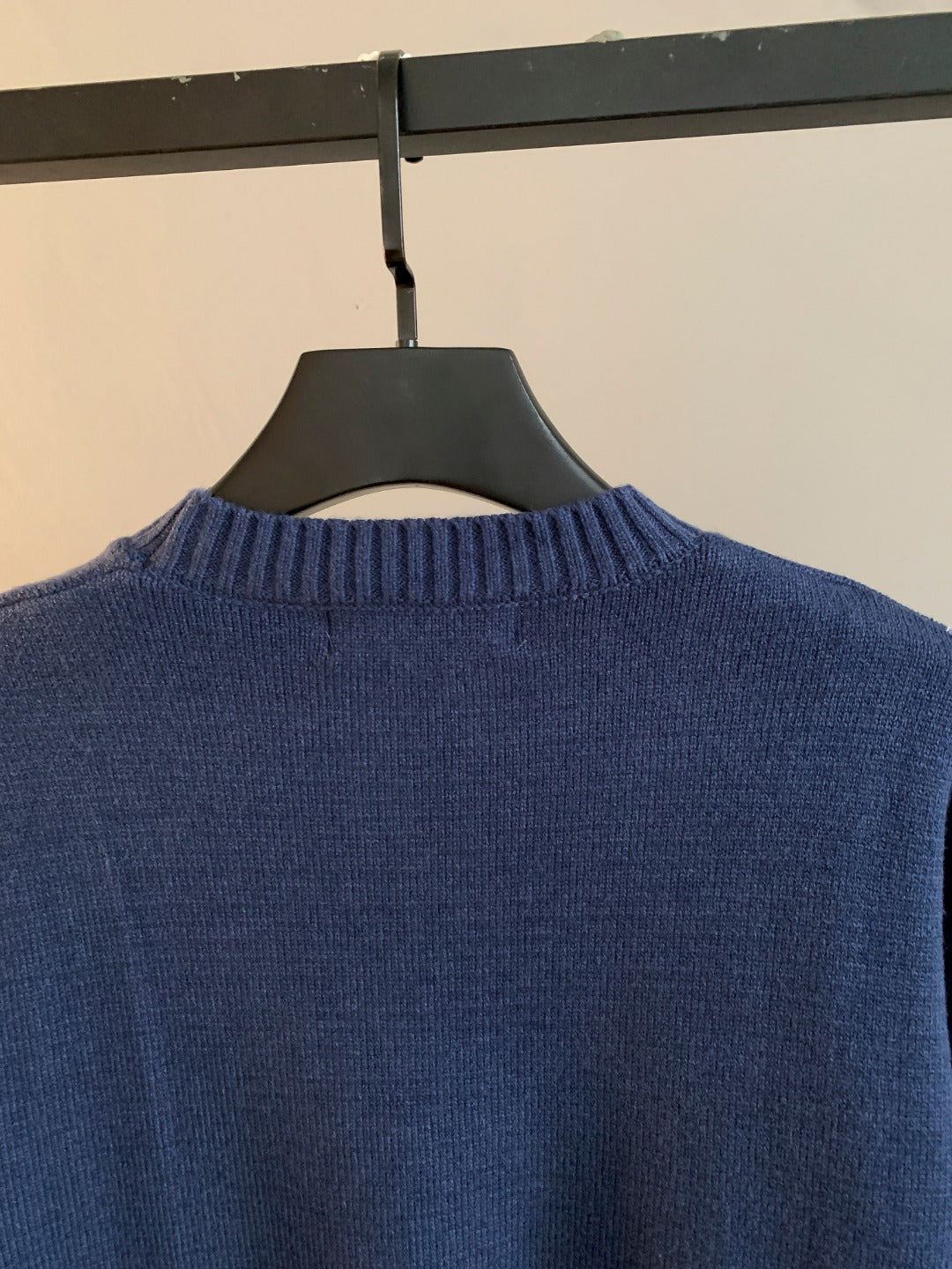 Navy blue knit crewneck sweater neckline, plain back