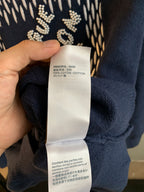 Navy blue knit sweater showing care label at inner collar