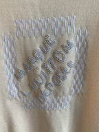 Cream knit sweater with raised rhinestone Louis Vuitton lettering across the chest