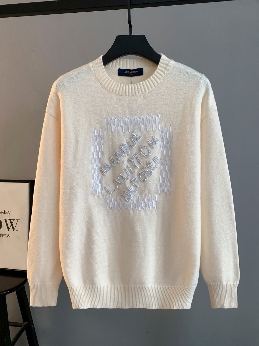 Cream knit crewneck sweater with Louis Vuitton logo appliqued in raised rhinestones