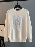 Cream knit crewneck sweater with Louis Vuitton logo appliqued in raised rhinestones