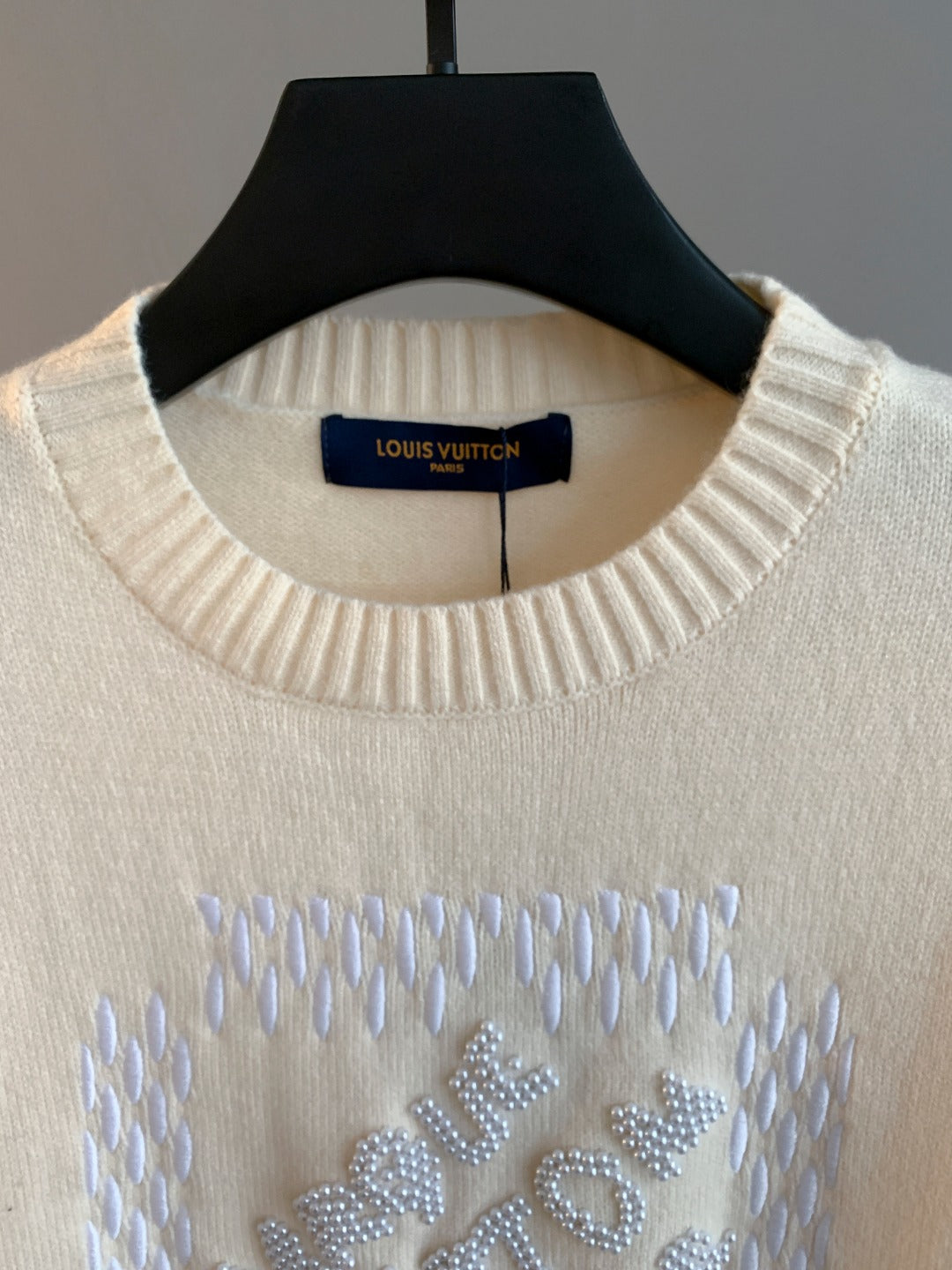 Cream ribbed crewneck sweater with Louis Vuitton label and rhinestone logo detail