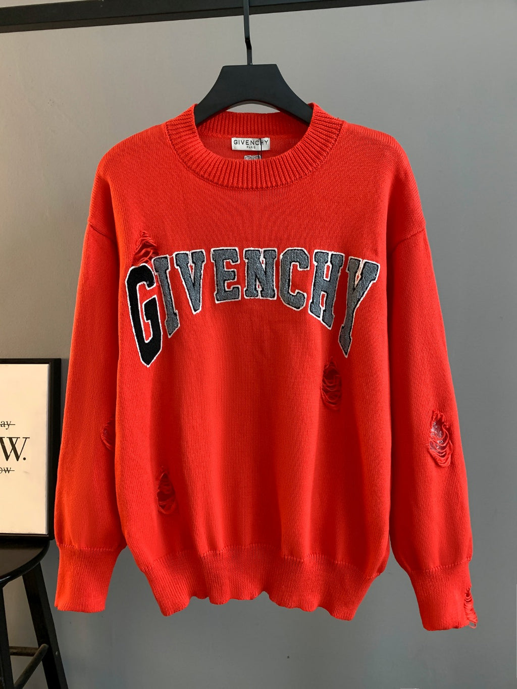 Givenchy red knit sweater with bold GIVENCHY logo across the chest